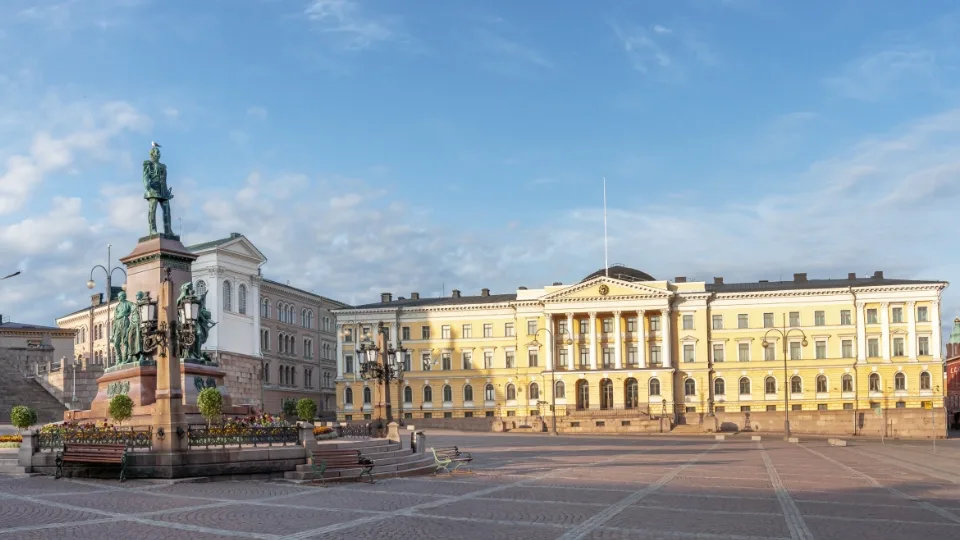 Skills badges change the playing field of Finnish adult learning. A neoclassical building with columns in an empty square, with a statue of a mounted figure under a clear sky at dawn or dusk.