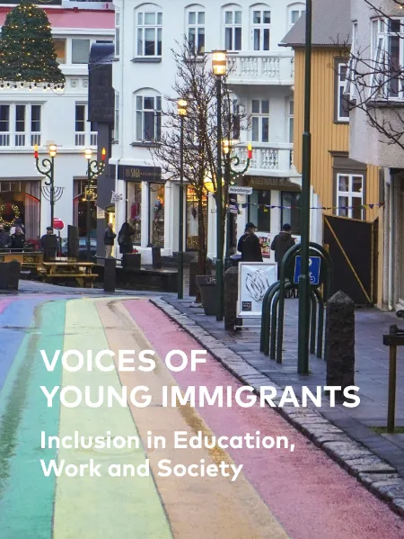Voices of Young Immigrants: Inclusion in Education, Work and Society A rainbow-colored pedestrian street in a European city with text overlay: "VOICES OF YOUNG IMMIGRANTS: Inclusion in Education, Work and Society." The background shows people walking, traditional buildings, and festive holiday decorations.